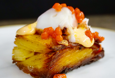 Crispy potato pavé with red pepper pearls and a dollop of creamy sauce, prepared by a private chef in Tenerife.