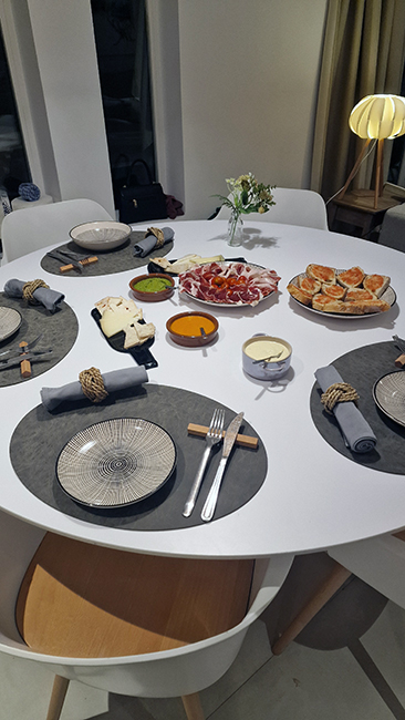 Elegant dinner table set with cheese, jamón, bread, and dips for a private chef dining experience in Tenerife.